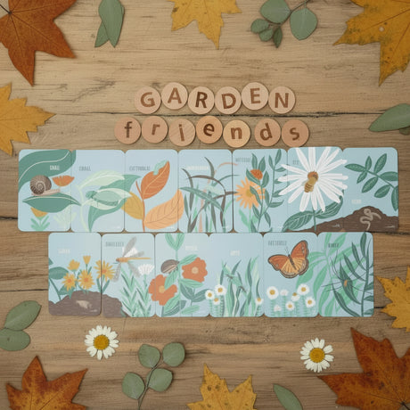 Wooden tiles with garden-themed illustrations on a wooden surface, featuring the word 'Garden Friends'.