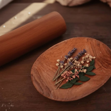 teak pestle and small tray on rustic wood table