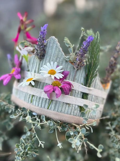 Childrens Crown with flowers and ribbons in nature