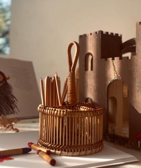 Wicker desk organizer with pencils on a desk