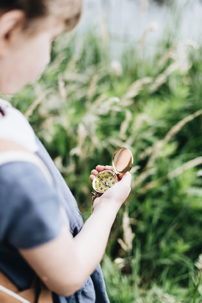 Girl holding brass compass