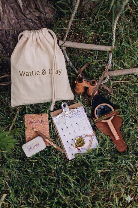 Wattle & Clay product set on grass with a drawstring bag