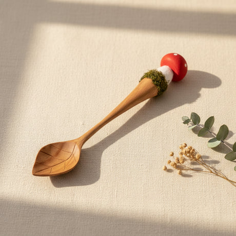 A wooden spoon with mushroom handle
