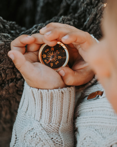 mini brass compass in nature 