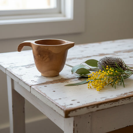Wooden jug with handle on a white background