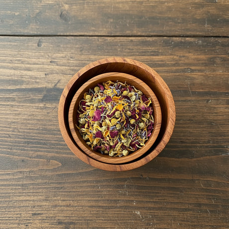 Wooden bowl with bath salts and flowers 