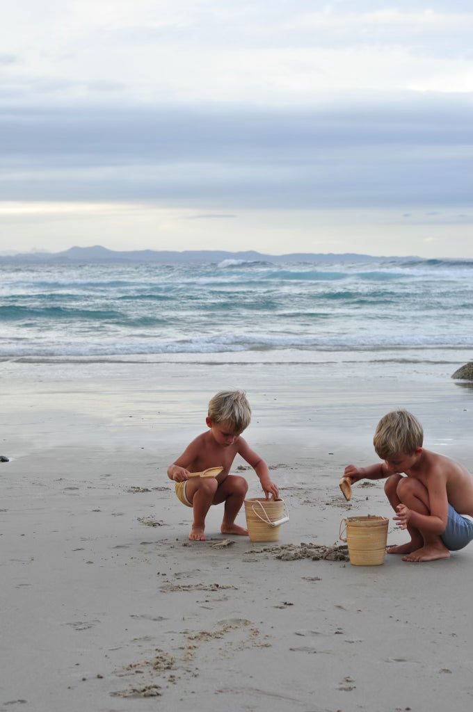 Bamboo Beach buckets and kids playing on beach