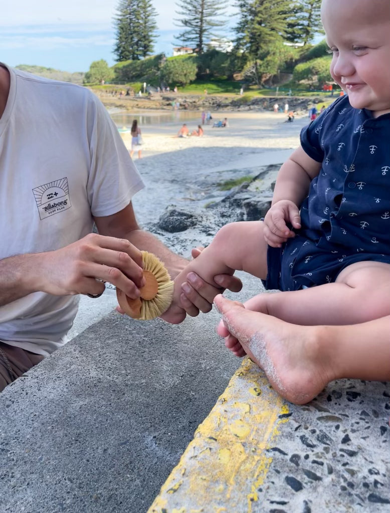 Beach Brush Removing Sand from toddler feet